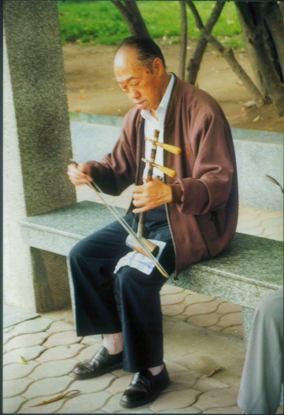 Man playing one-stringed instrument china 1999