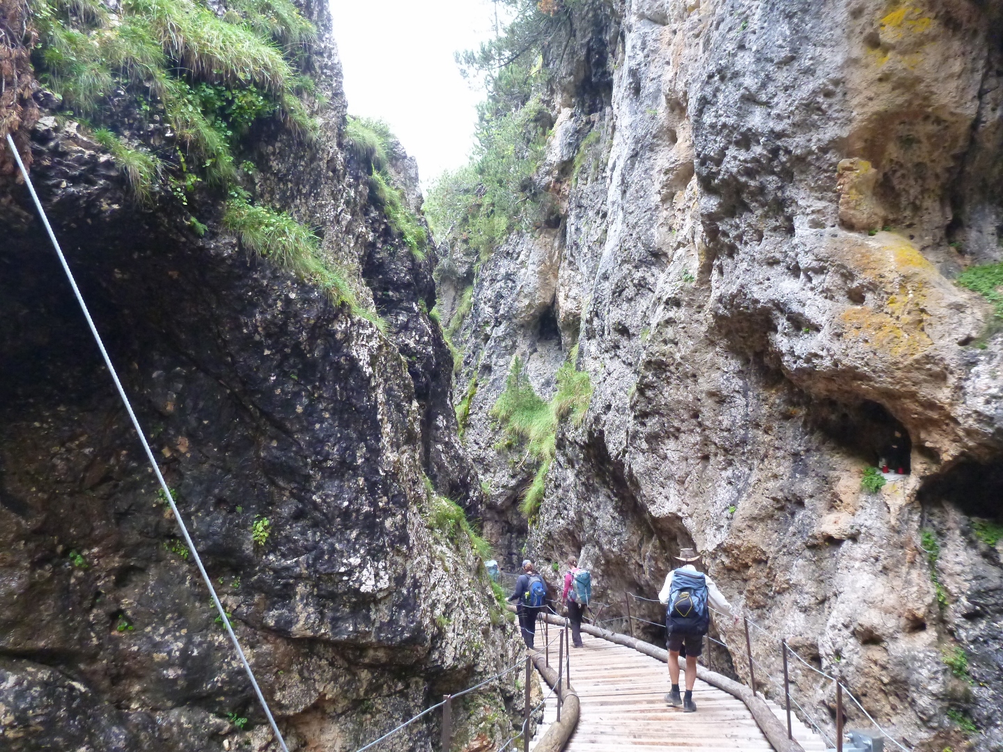 trail above canyon stream trekking in dolomites italy aug 2014